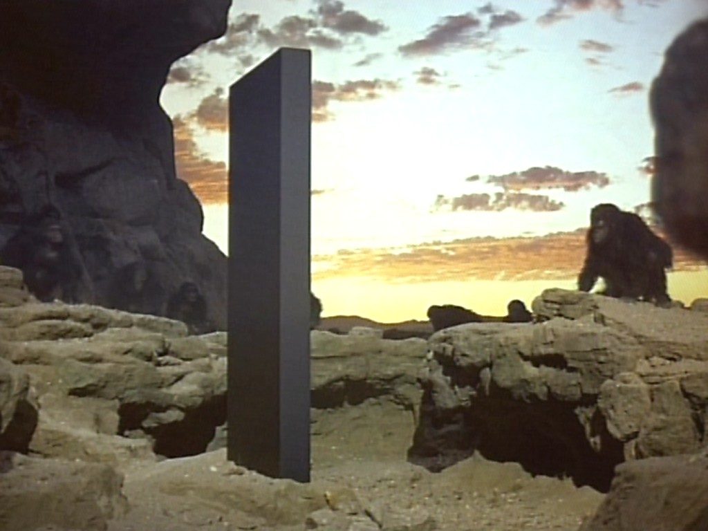 Scene from 2001 Space Odyssey: big ape meets monolith.